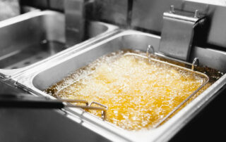 A frying machine at a quick service restaurant, cooking food